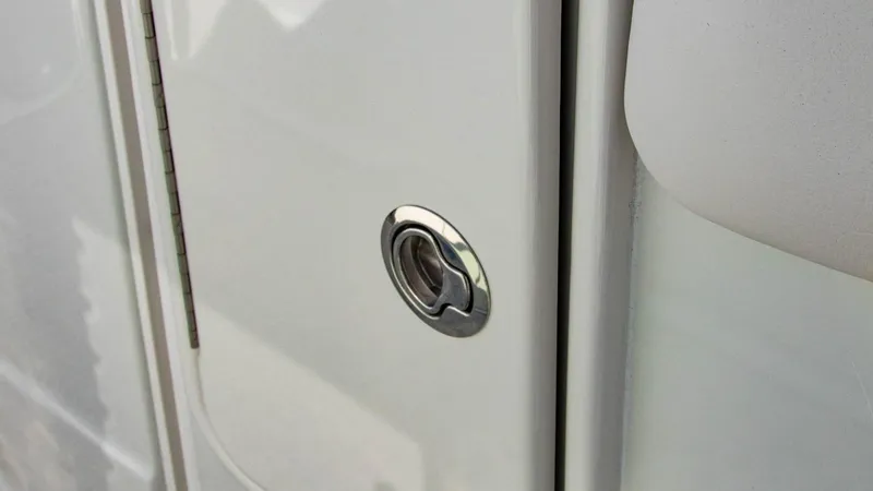 Slide: The Image of Close-up of 2023 Crownline 290 XSS boat's sleek white exterior with chrome handle. - 27