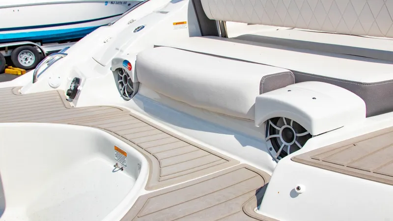 Slide: The Image of 2023 Crownline 290 XSS boat interior with cushioned seating and built-in speakers. - 20