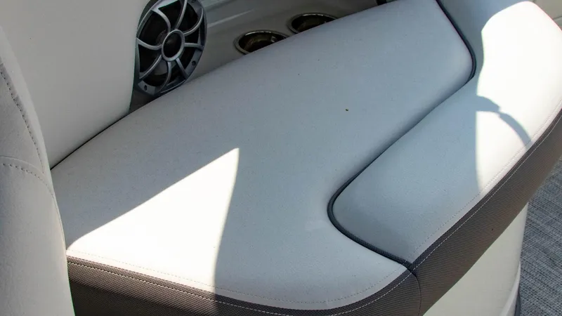 Slide: The Image of 2023 Crownline 290 XSS boat interior seating with speaker and cup holders. - 25