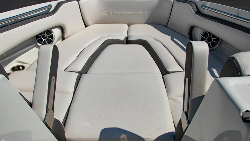 Slide: The Image of 2023 Crownline 290 XSS boat interior with white cushioned seating and built-in speakers. - 5