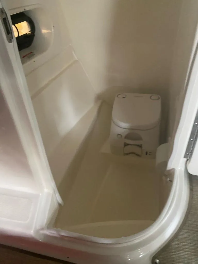 Slide: The Image of 2020 Sea Ray SLX 250 boat interior bathroom view. - 6