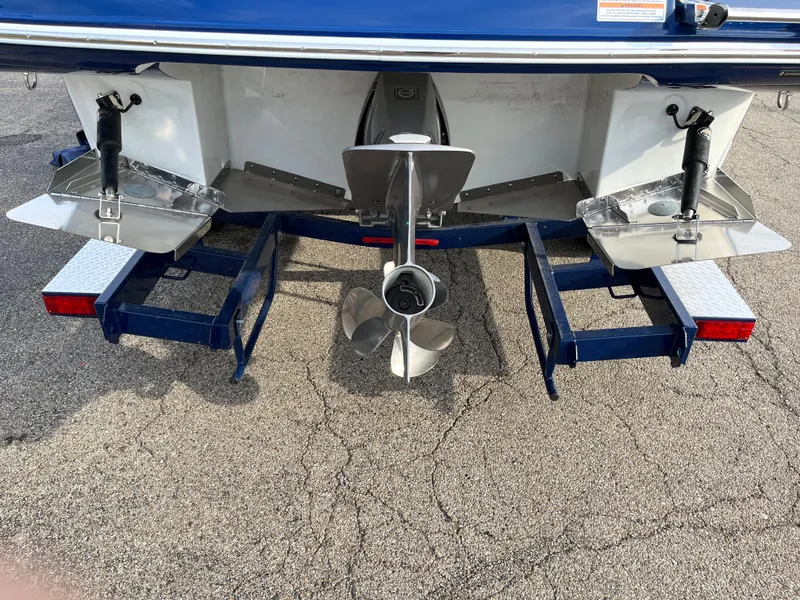 Slide: The Image of 2023 Crownline 260 SS SURF boat stern with propeller and trim tabs. - 4
