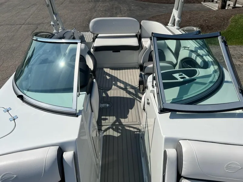 Slide: The Image of 2023 Crownline 260 SS boat interior with open bow seating and dual windshields. - 5