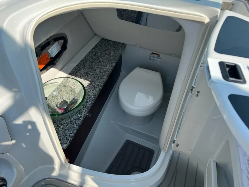 Slide: The Image of 2023 Crownline 260 SS boat interior bathroom with toilet and sink. - 6