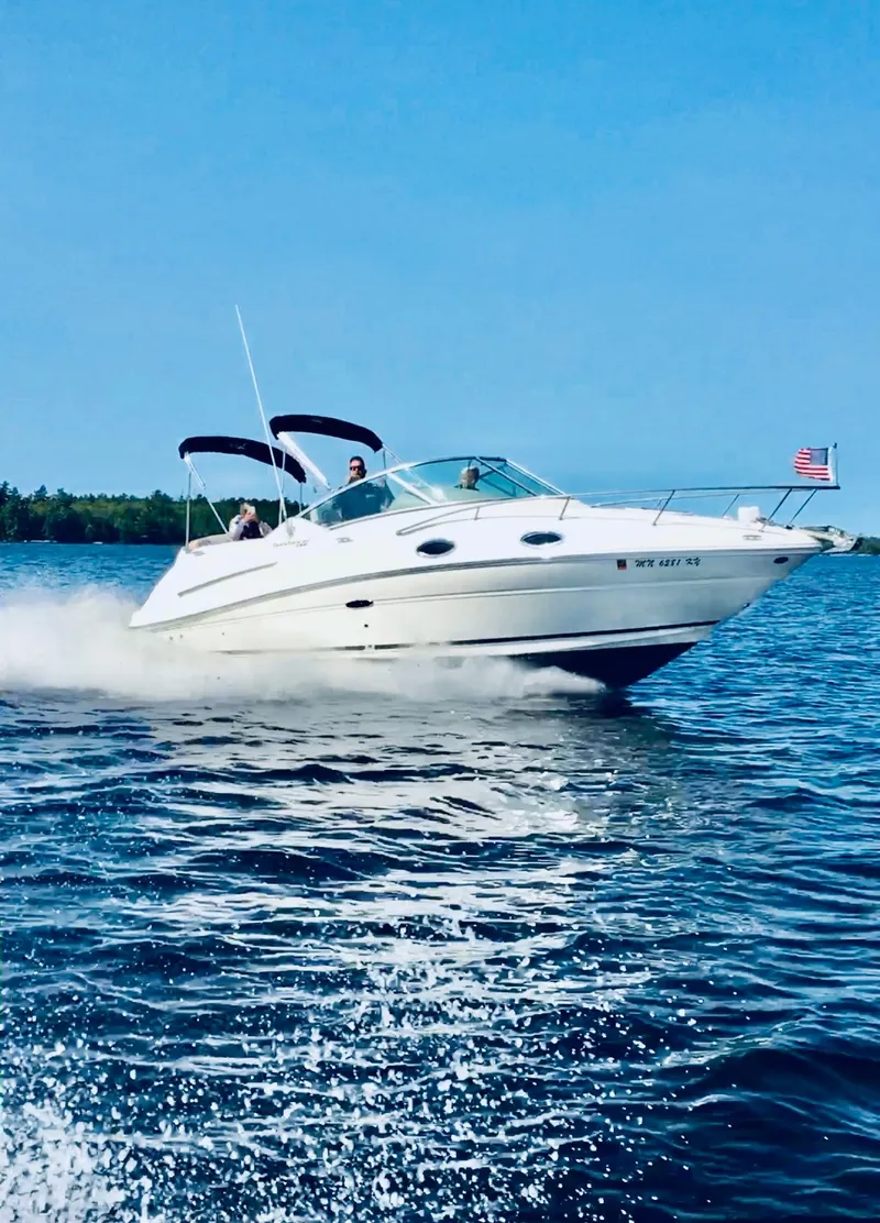 The Image of 2012 Sea Ray 240 Sundancer cruising on a sunny day with American flag. - 0