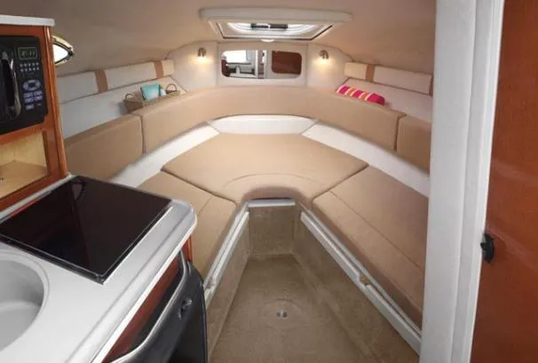 Slide: The Image of Interior of 2012 Sea Ray 240 Sundancer boat with cozy seating and kitchenette. - 6