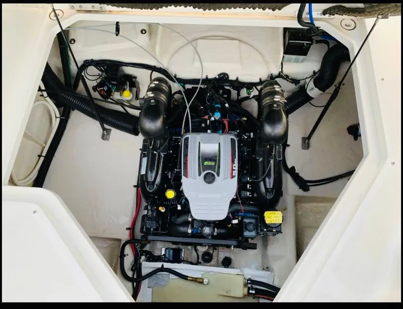 Slide: The Image of Engine compartment of a 2012 Sea Ray 240 Sundancer boat, showcasing the motor and components. - 9