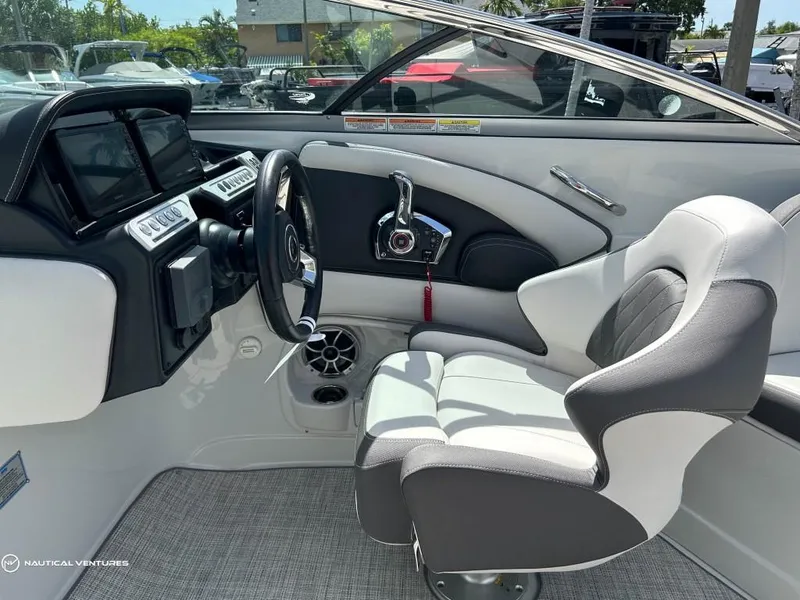 Slide: The Image of 2024 Crownline E290 XS boat cockpit with modern steering and control panel. - 5