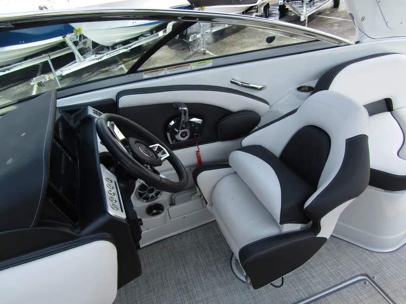 Slide: The Image of 2024 Crownline 270 XSS boat interior with modern steering and seating. - 14