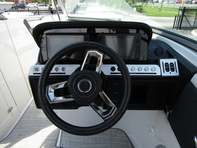 Slide: The Image of 2024 Crownline 270 XSS dashboard with modern steering wheel and dual displays. - 15