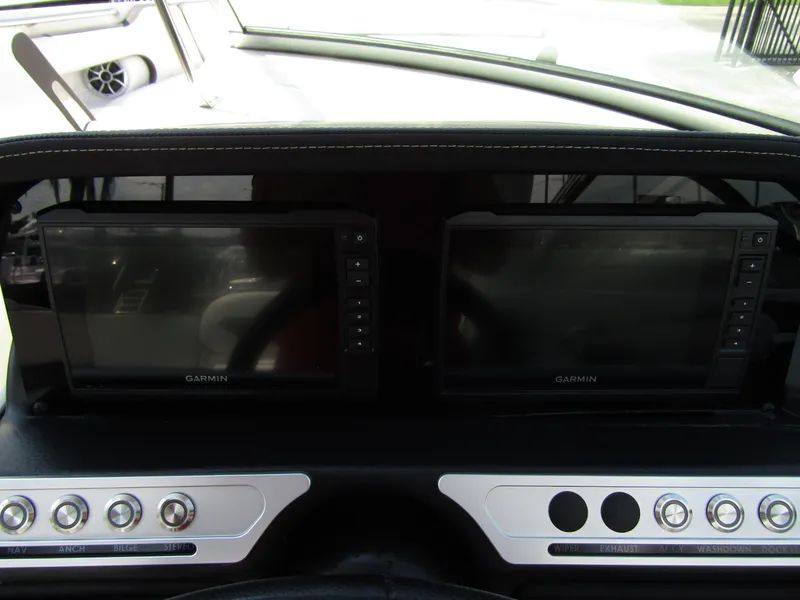 Slide: The Image of 2024 Crownline 270 XSS dashboard with dual Garmin displays and control buttons. - 16