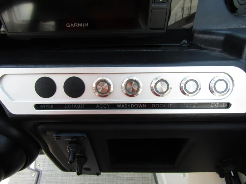 Slide: The Image of Control panel of 2024 Crownline 270 XSS boat with labeled switches and Garmin display. - 20