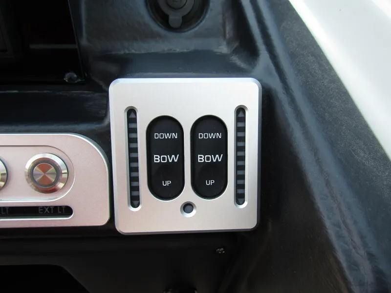 Slide: The Image of 2024 Crownline 270 XSS boat control panel with bow adjustment switches. - 21