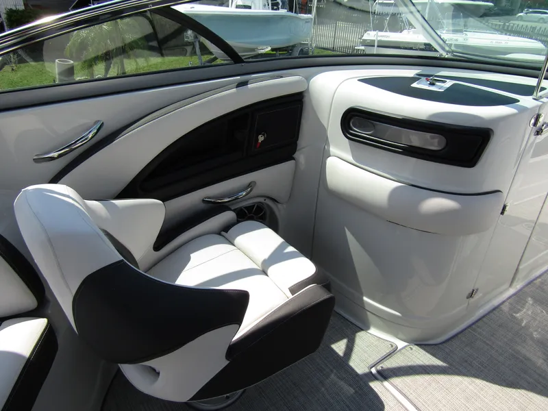 Slide: The Image of 2024 Crownline 270 XSS boat interior with sleek seating and modern dashboard design. - 23