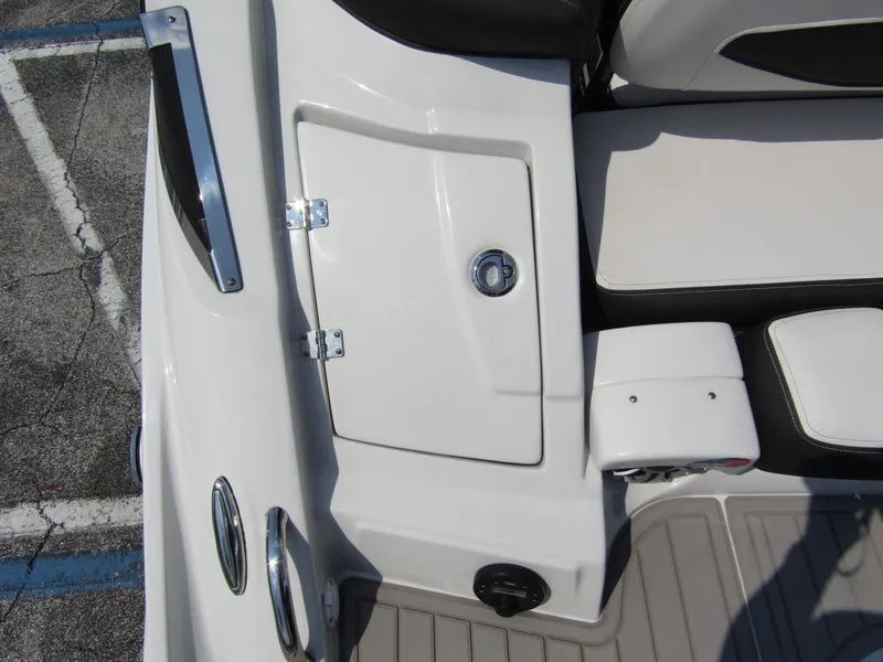 Slide: The Image of 2024 Crownline 270 XSS boat interior with white seating and storage compartment. - 35