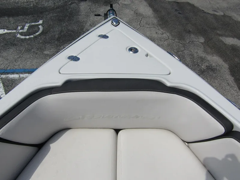Slide: The Image of 2024 Crownline 270 XSS boat bow with cushioned seating and sleek design. - 7