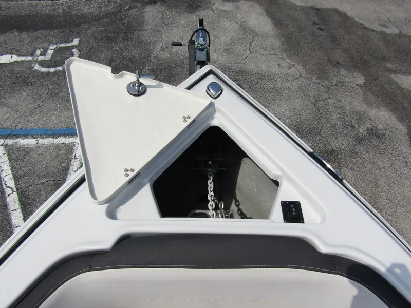 Slide: The Image of 2024 Crownline 270 XSS boat anchor compartment with open hatch. - 8