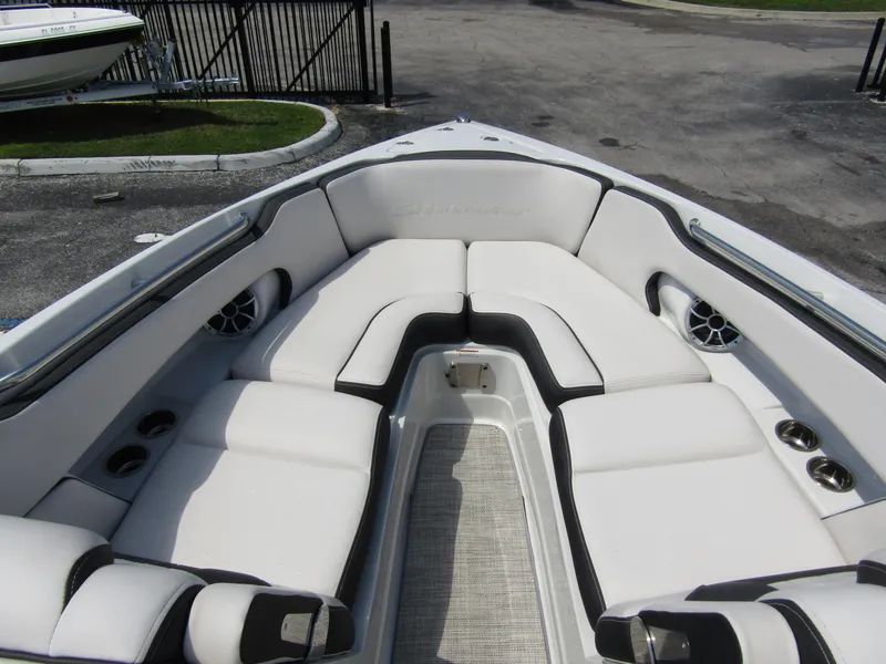 Slide: The Image of 2024 Crownline 270 XSS boat interior with plush seating and cup holders. - 9