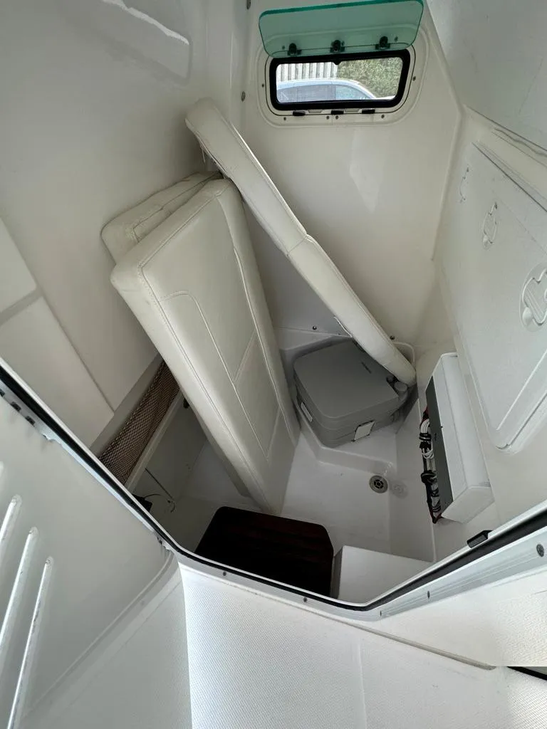 Slide: The Image of 2021 Everglades 253 boat interior cabin with seating and storage. - 10