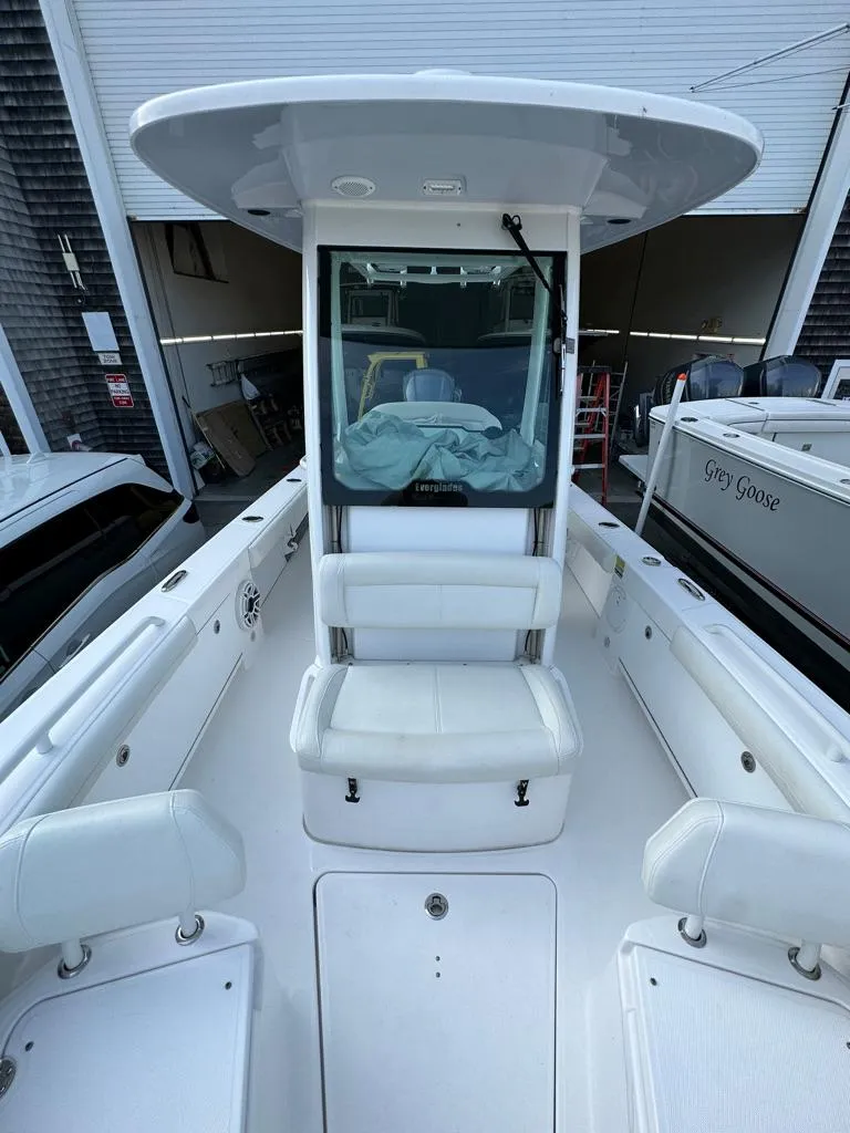 Slide: The Image of 2021 Everglades 253 boat with white seating and center console. - 12