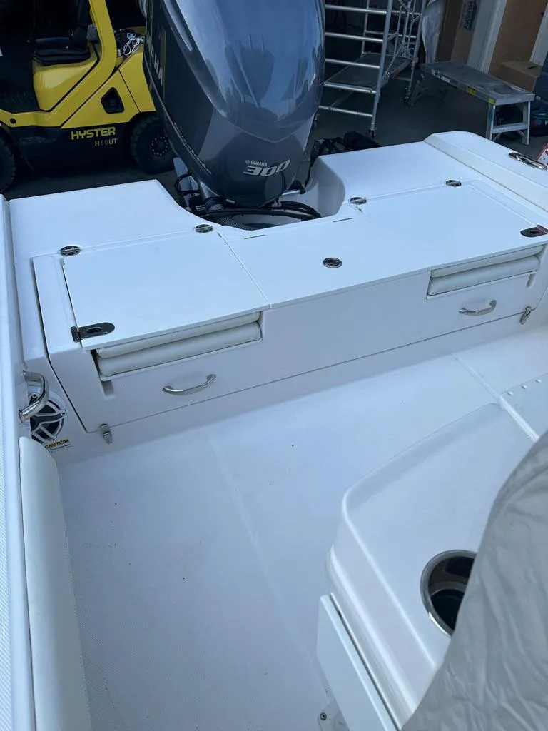 Slide: The Image of 2021 Everglades 253 boat with a powerful outboard motor and ample storage compartments. - 13