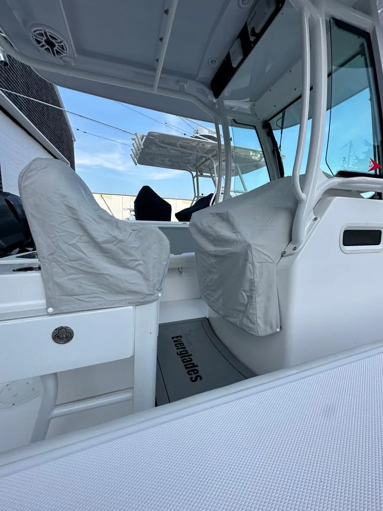 Slide: The Image of 2021 Everglades 253 boat interior with covered seats and modern design. - 14