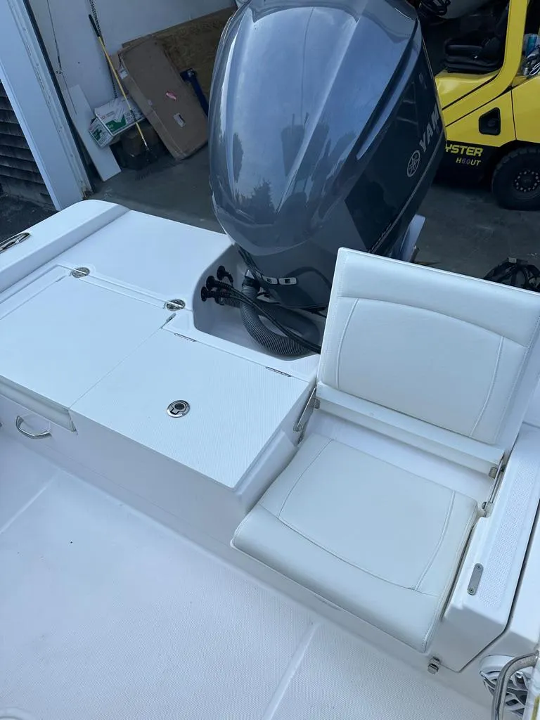 Slide: The Image of 2021 Everglades 253 boat with white seating and powerful outboard motor. - 7