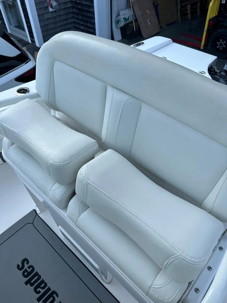 Slide: The Image of 2021 Everglades 253 boat with white cushioned seating. - 8