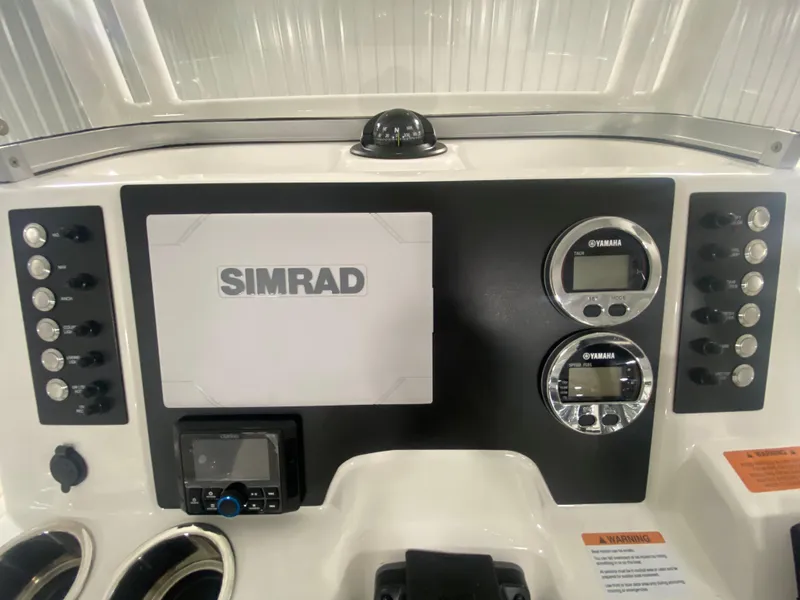 Slide: The Image of 2024 Robalo R222 Center Console dashboard with Simrad electronics and Yamaha gauges. - 14