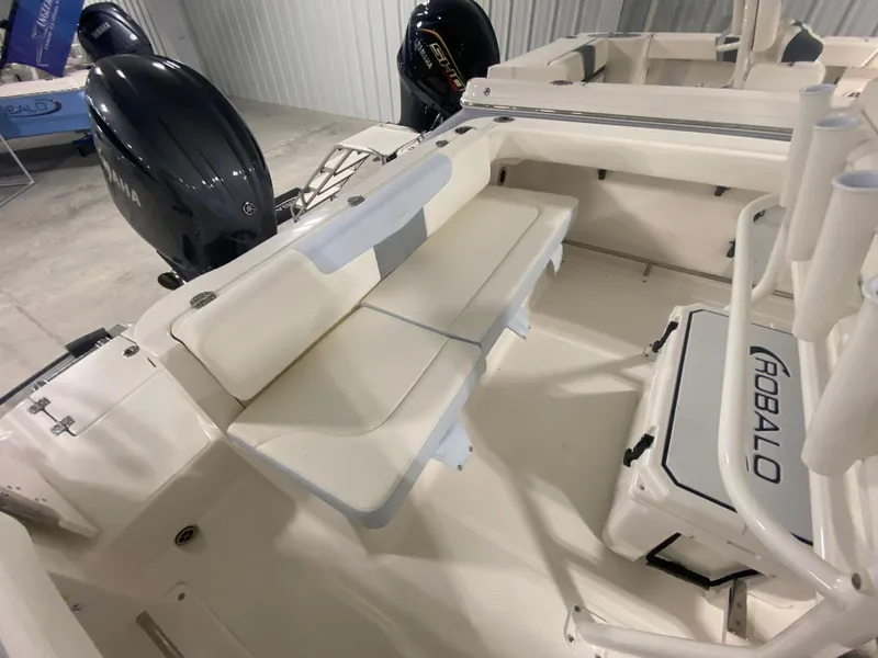 Slide: The Image of 2024 Robalo R222 Center Console boat interior with seating and twin outboard engines. - 5