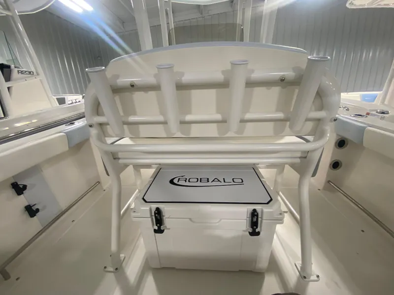 Slide: The Image of 2024 Robalo R222 Center Console boat interior with rod holders and cooler. - 8
