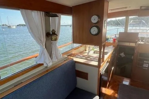 Slide: The Image of Interior of a 1978 Grand Banks Trawler with wood paneling and nautical decor. - 11