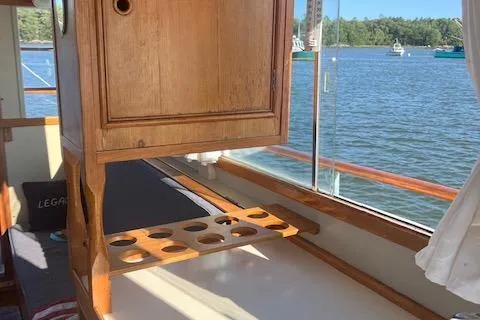Slide: The Image of 1978 Grand Banks Trawler interior with wooden cabinetry and lake view through window. - 18