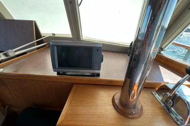 Slide: The Image of 1978 Grand Banks Trawler helm with navigation equipment and wooden interior details. - 19