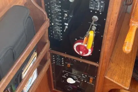 Slide: The Image of 1978 Grand Banks Trawler control panel with switches and wooden shelving. - 24