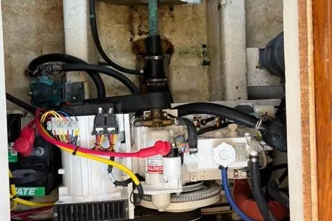 Slide: The Image of Engine compartment of a 1978 Grand Banks Trawler with visible wiring and components. - 28