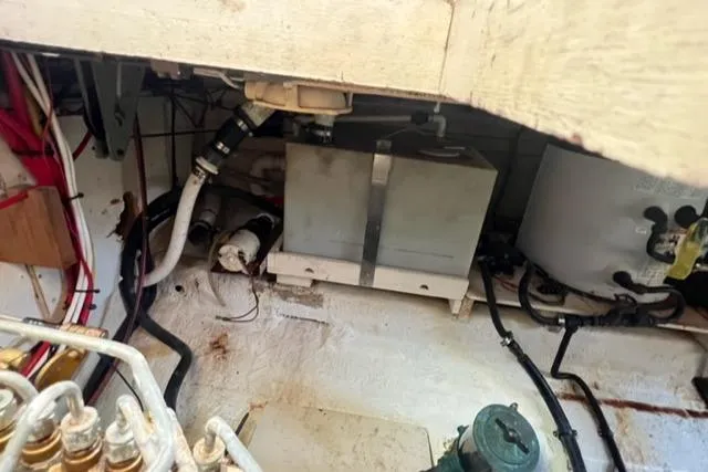 Slide: The Image of Engine room of 1978 Grand Banks Trawler, showcasing mechanical components and piping. - 29