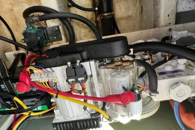 Slide: The Image of Engine compartment of a 1978 Grand Banks Trawler with visible wiring and components. - 31