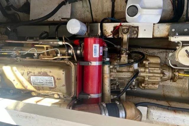 Slide: The Image of Engine compartment of a 1978 Grand Banks Trawler, showcasing mechanical components and wiring. - 35