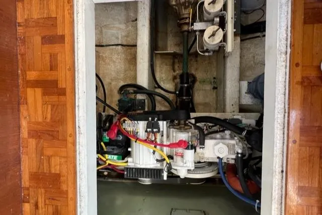 Slide: The Image of Engine compartment of a 1978 Grand Banks Trawler with visible wiring and components. - 37