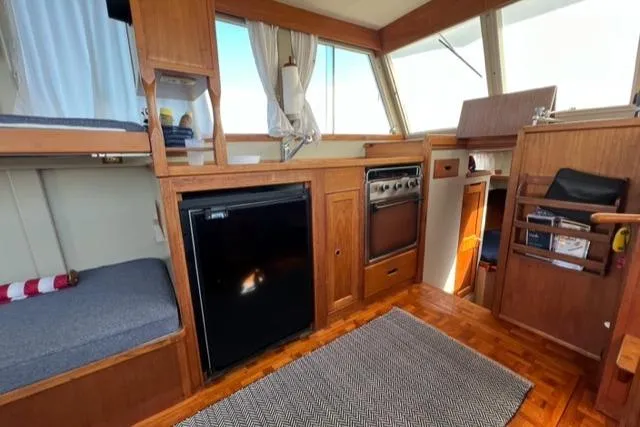 Slide: The Image of Interior of 1978 Grand Banks Trawler with wood finish, bunk, and kitchenette. - 4