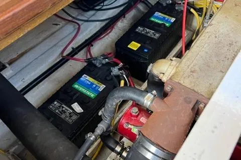 Slide: The Image of 1978 Grand Banks Trawler engine compartment with batteries and wiring. - 25