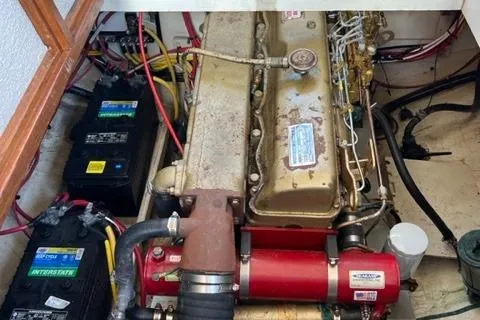 Slide: The Image of Engine room of a 1978 Grand Banks Trawler with visible batteries and wiring. - 26