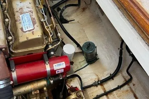 Slide: The Image of Engine compartment of a 1978 Grand Banks Trawler, showcasing mechanical components and wiring. - 27