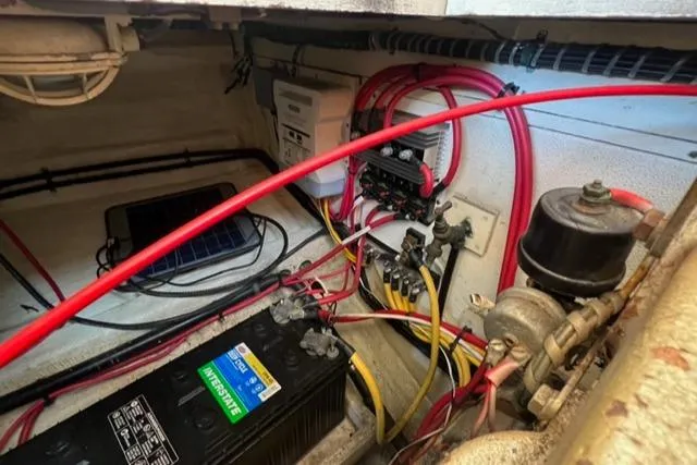 Slide: The Image of Electrical system of a 1978 Grand Banks Trawler with battery and wiring components. - 30