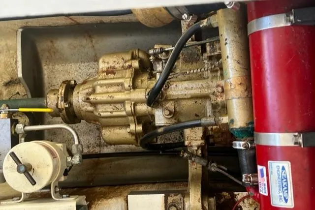 Slide: The Image of Engine compartment of a 1978 Grand Banks Trawler, showcasing mechanical components and piping. - 34