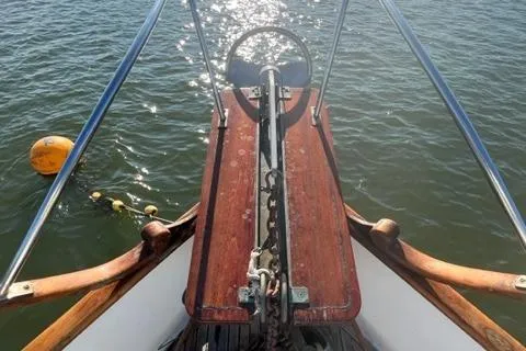 Slide: The Image of Bow of 1978 Grand Banks Trawler with anchor chain and calm water. - 49