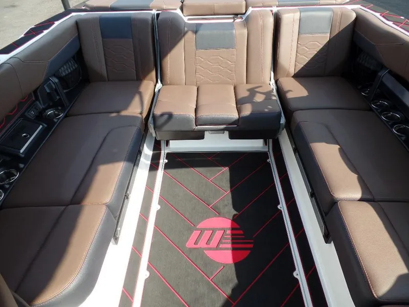 Slide: The Image of 2024 Malibu 23 LSV interior with brown leather seating and custom flooring. - 10