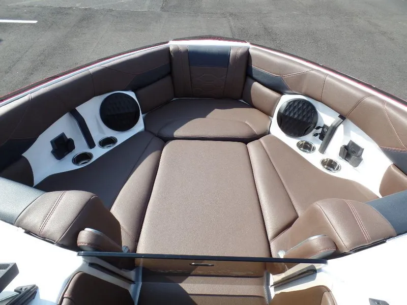 Slide: The Image of 2024 Malibu 23 LSV boat interior with brown seating and built-in speakers. - 13