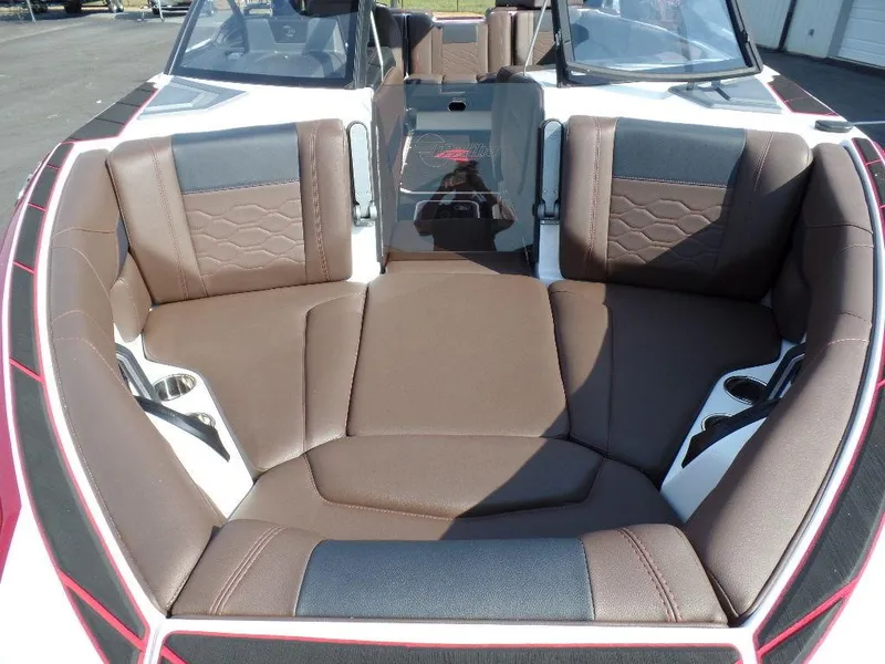 Slide: The Image of 2024 Malibu 23 LSV boat interior with brown leather seating and cup holders. - 4
